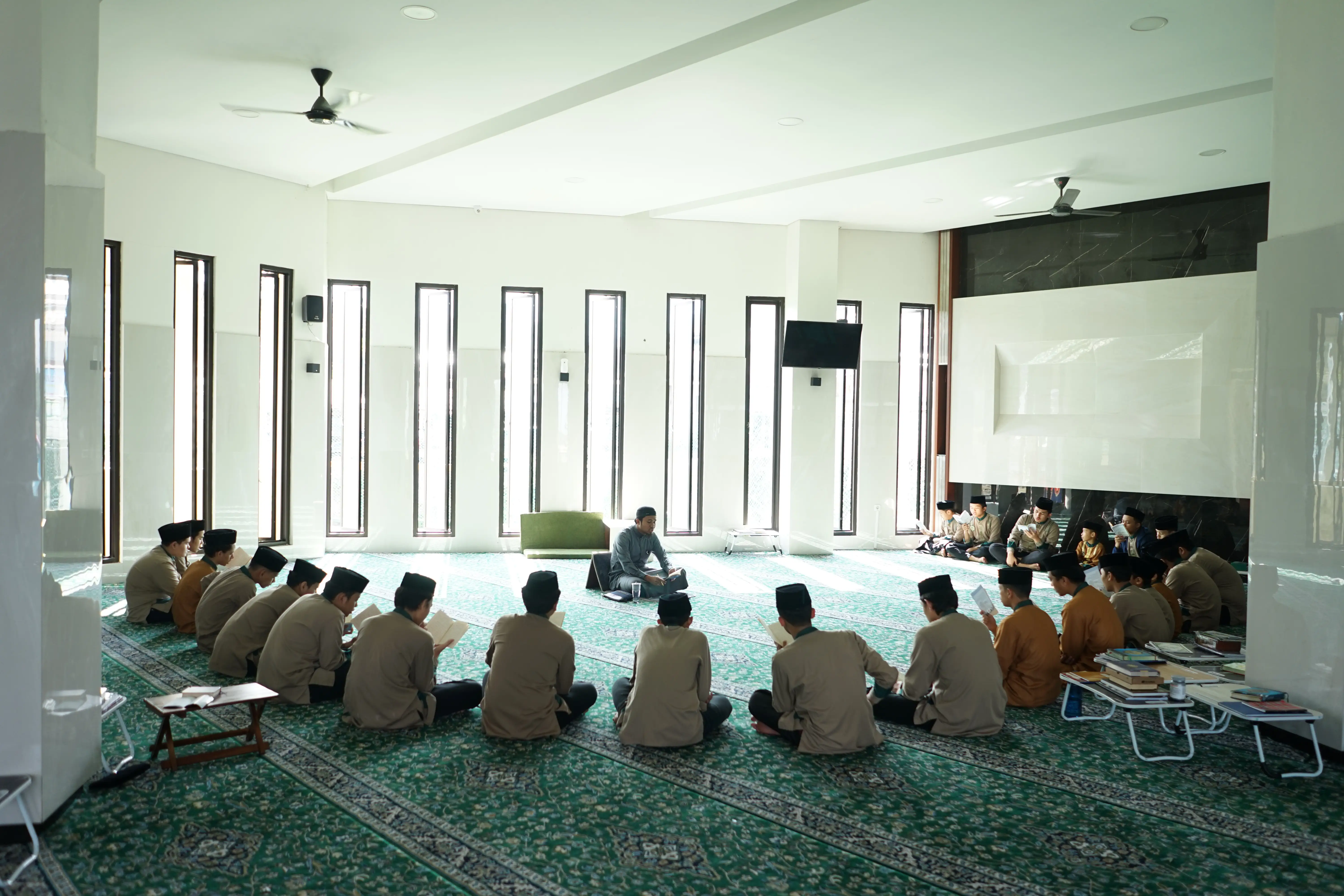 Students gathering in a circle reciting Quran